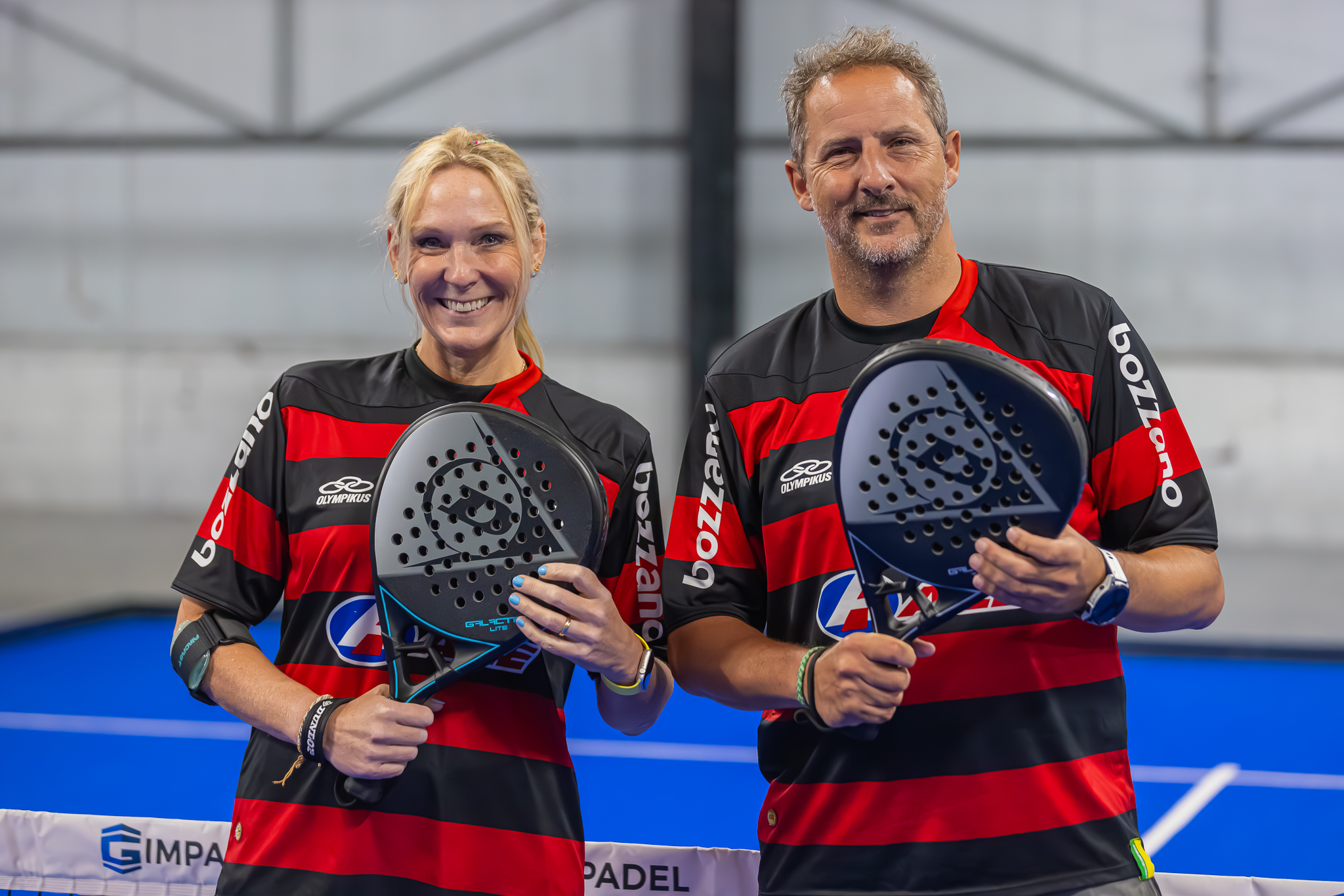 Two smiling players holding padel rackets at RC24