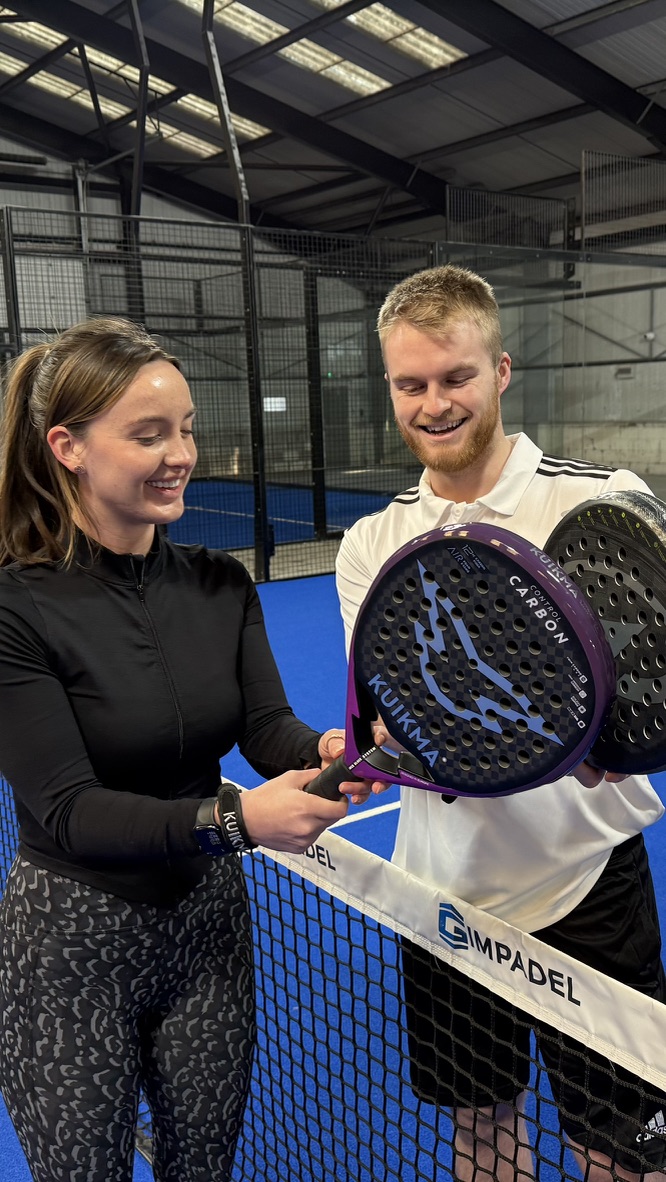 Taylor teaching his sister beside the padel net